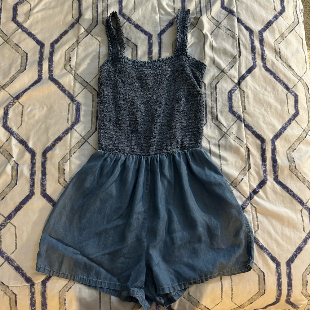 navy blue romper with elastic waistband and ruffle trim